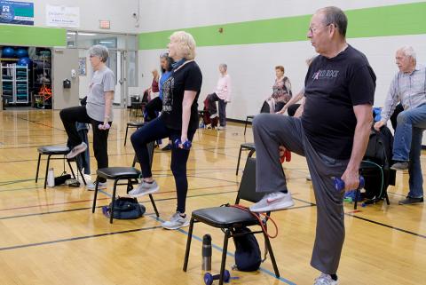 Older adults doing chair exercises