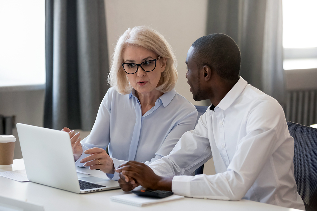 Woman and man talking at a computer