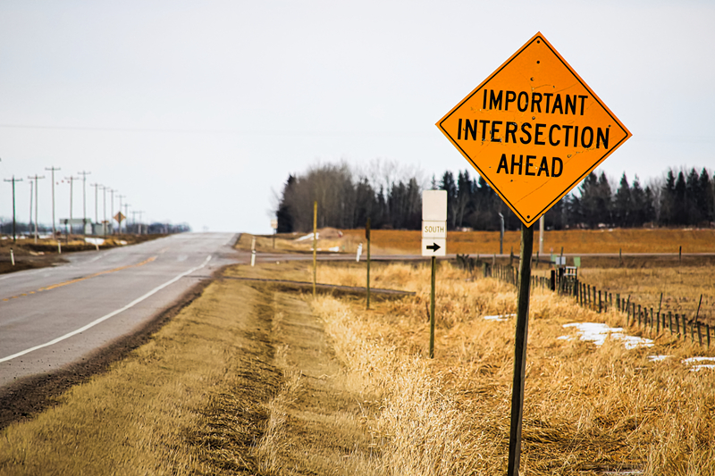 Road with sign that says important intersection ahead