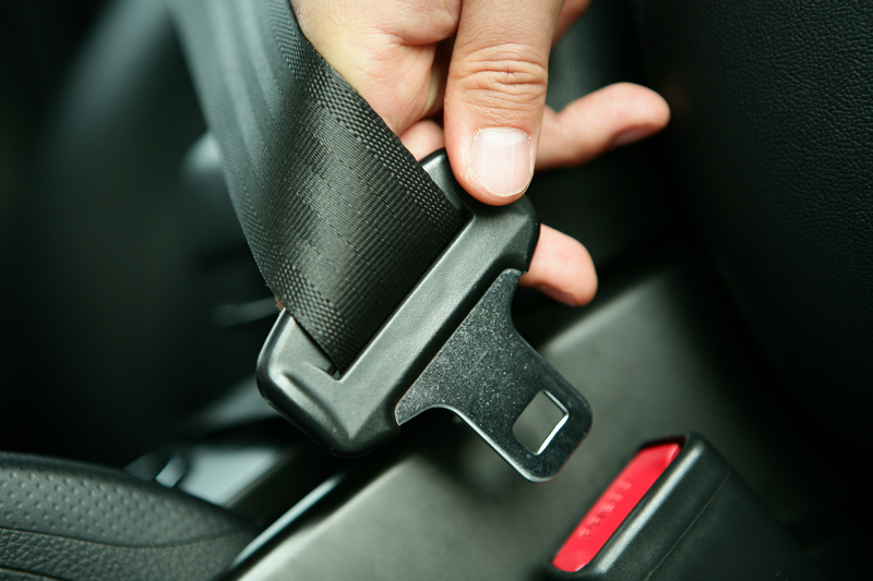 Close up image of seat belt being buckled