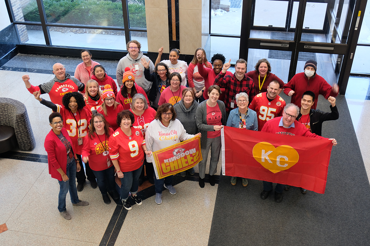 MARC team members wearing red and holding a KC flag