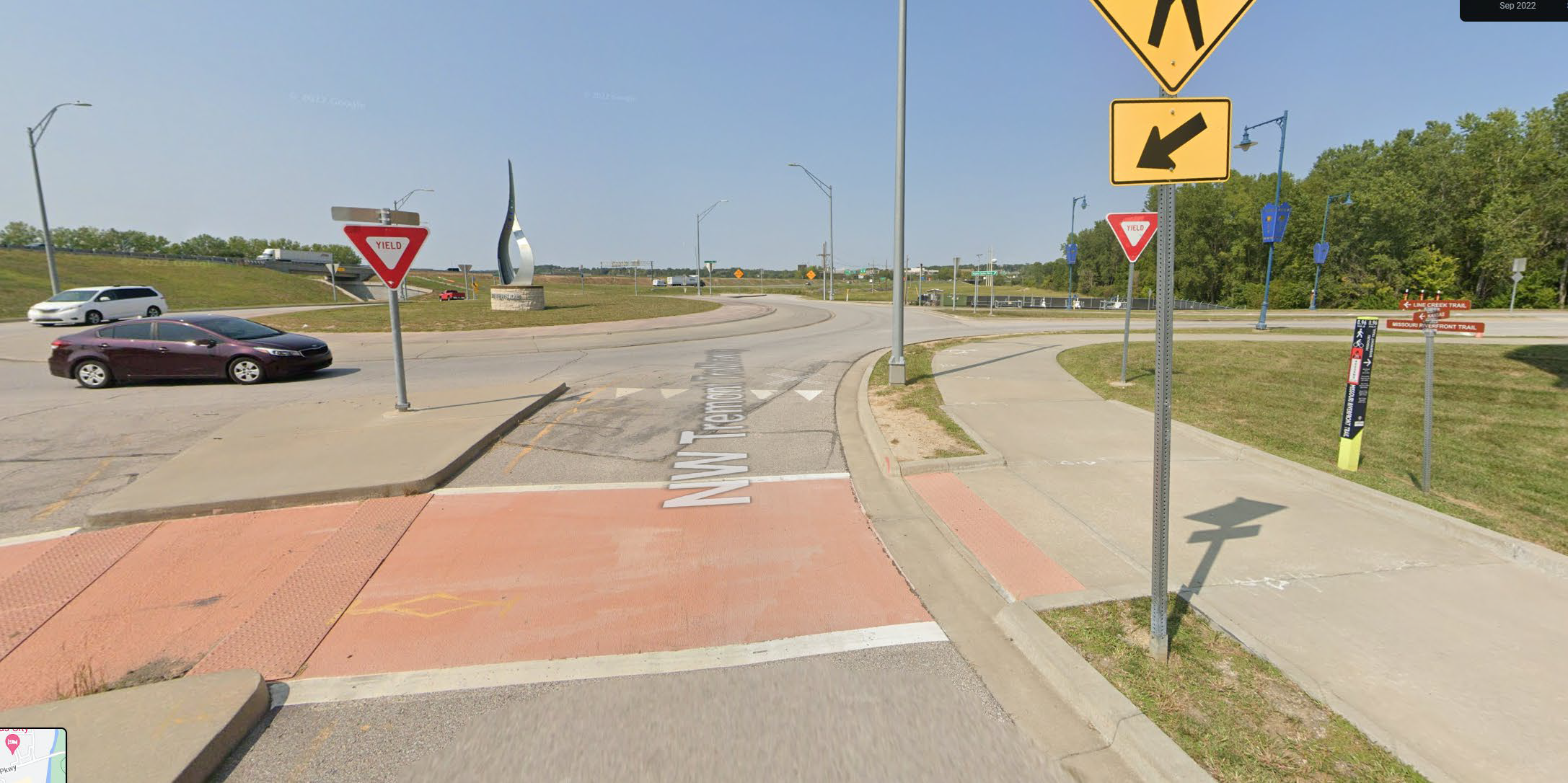 Bicyclist riding on the sidewalk in the city of Riverside, Missouri