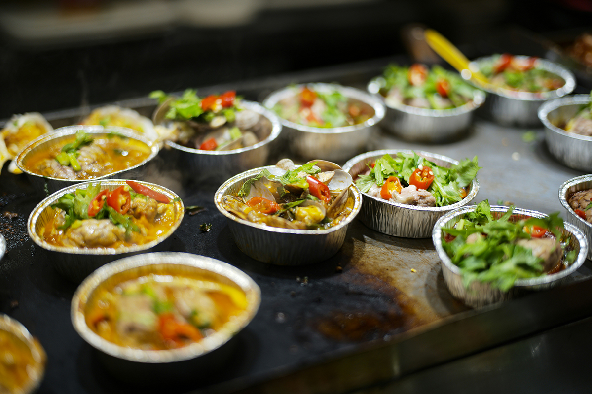 Food in foil containers at a restaurant
