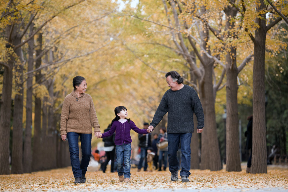 grandparents walking with grandchild