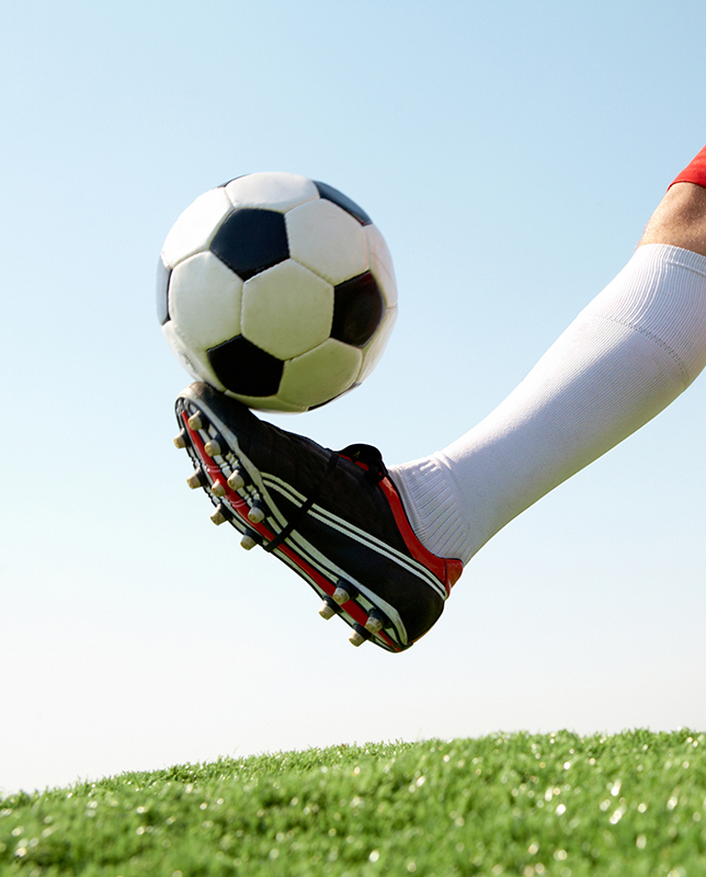 Foot kicking a soccer ball