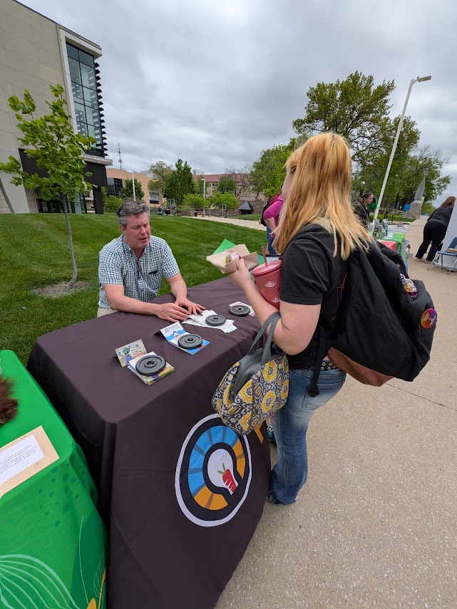 Visitor speaks with MARC staff at table branded for KC Foodwise initiative