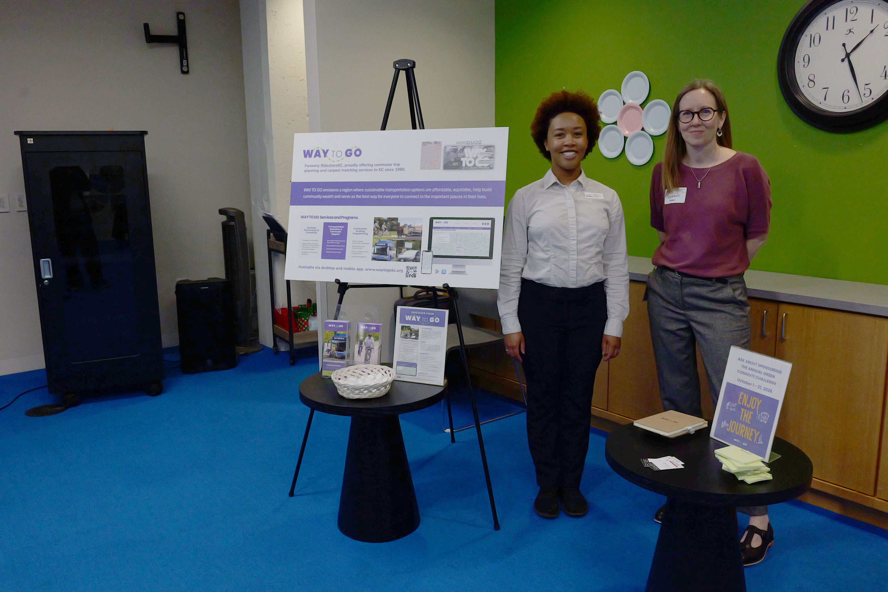 WAY TO GO team standing next to their board