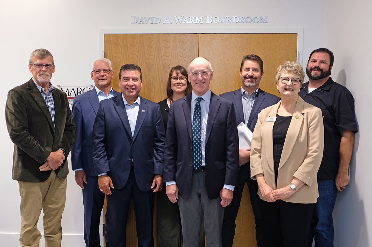 MARC Boar of Directors leadership with David Warm in front of the newly unveiled David A. Warm Boardroom