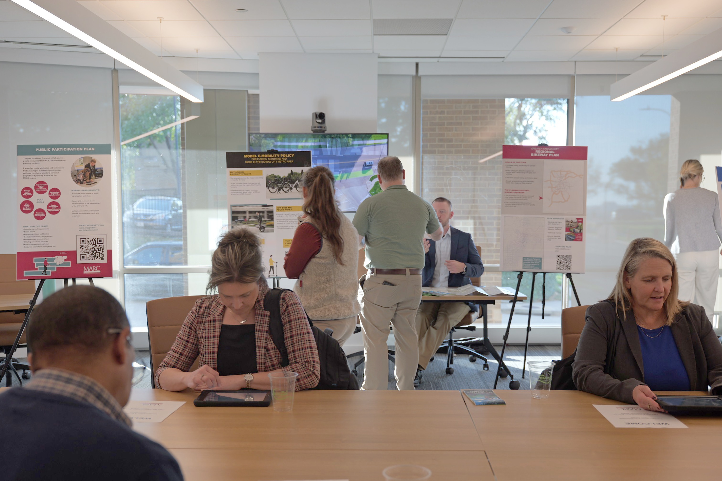 People taking survey at the Transportation & Environment open house