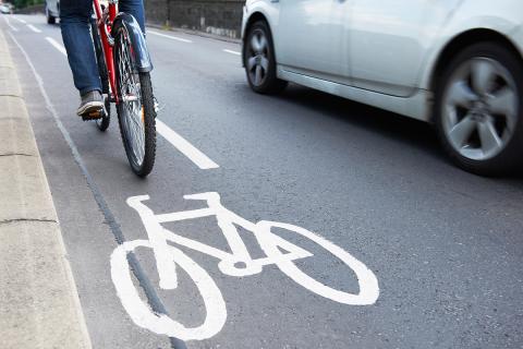 Bike in protected bike lane next to car
