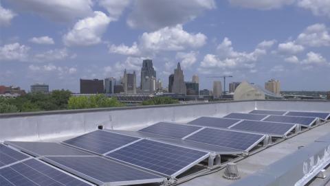 Solar panels in the foreground of the Kansas City skyline