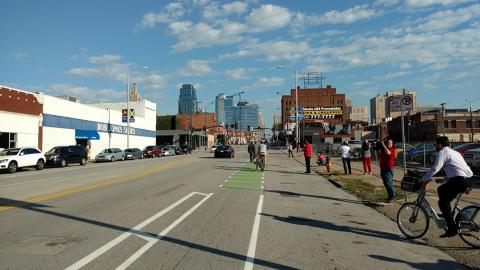 People riding bikes on bike lane along Grand Avenue