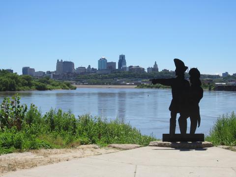 Kansas City skyline from a distance with the Missouri River in the foreground 