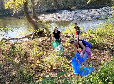 Group cleaning up a waterway as part of a grant project