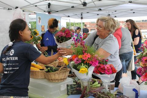 Woman buying flowers at farmers market