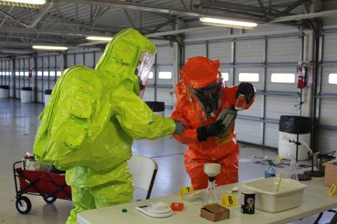 Hazardous materials team inspecting items