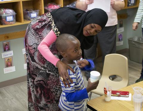 Head Start teacher and student in a classroom