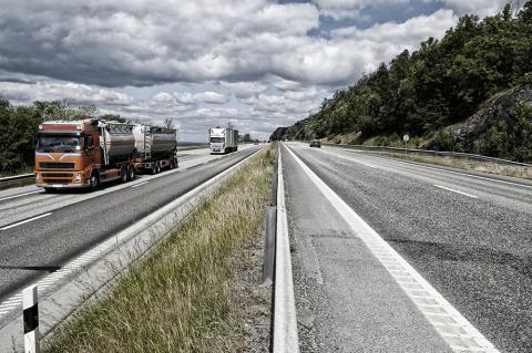 Orange semi truck on highway