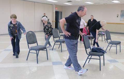Group of older adults stretching
