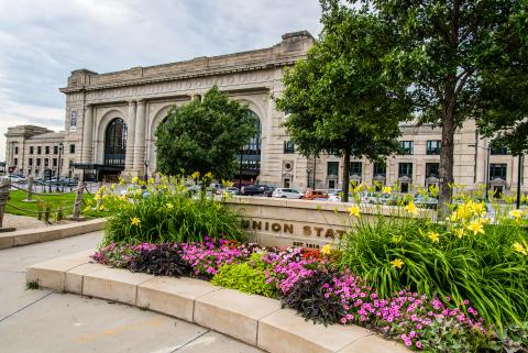 Union Station with stone sign and spring flowers