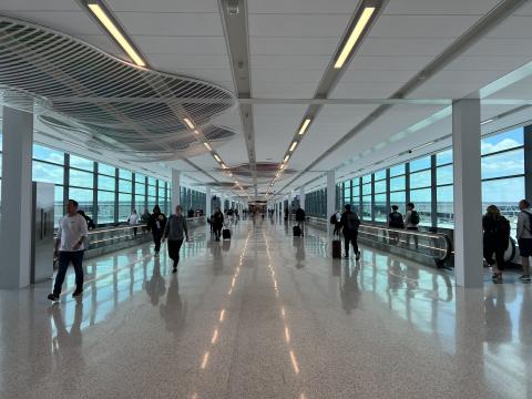 Crowded KCI terminal hallway with moving walkways on both sides