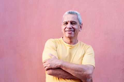 smiling man pink wall