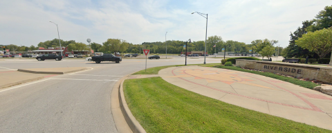 City of Riverside, Missouri street with a crosswalk, car, and wide sidewalk