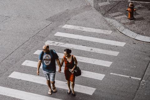 A couple crossing a crosswalk