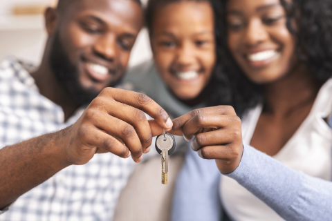 photo of family with keys to new home