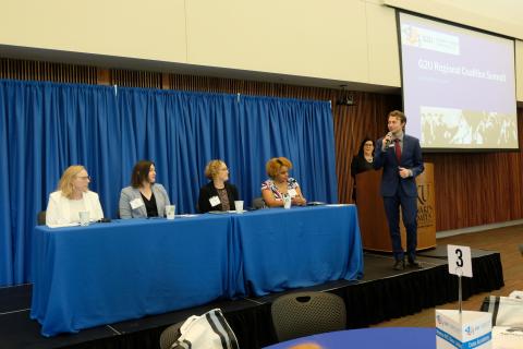 Panelists on stage at the BEST Conference Center at KU Edwards Campus