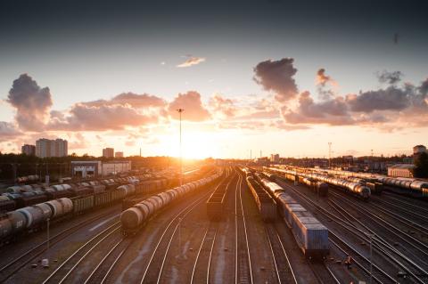 Trains over tracks with sunset 