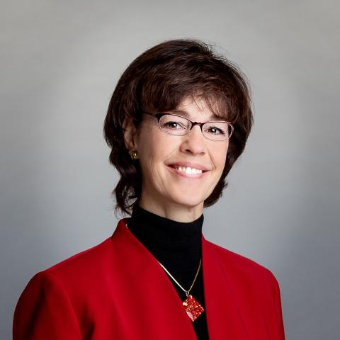 Woman with dark hair wearing a red jacket