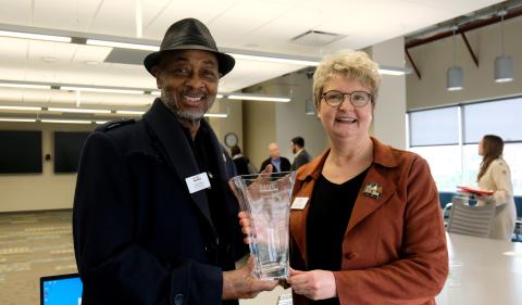 Blue Springs Mayor Carson Ross receives a vase from Johnson County Commissioner Janee' Hanzlick for his service as MARC Board chair. Commissioner Hanzlick began her term as chair on April 1, 2024.