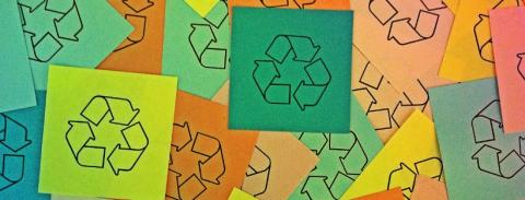 Colorful paper squares with the recycling logo