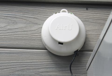 Air quality sensor mounted to the exterior of a residential house.