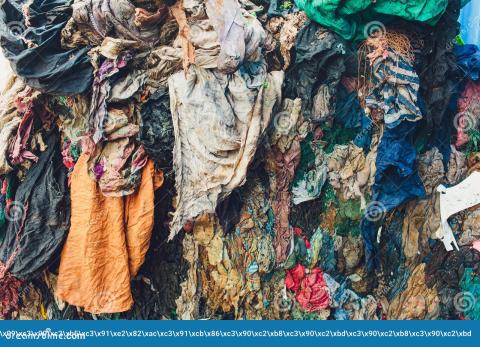 Dirty clothes stacked in a landfill