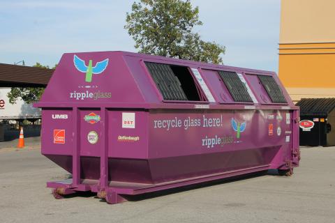 A purple Ripple Glass bin in a parking lot