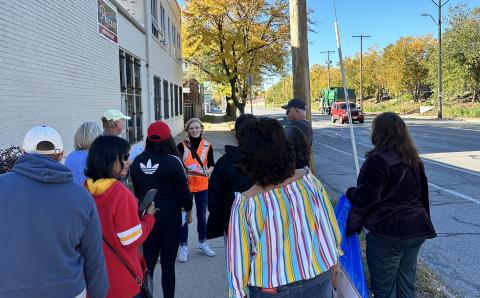 Walking tour led by woman in high visibility vest along Southwest Boulevard