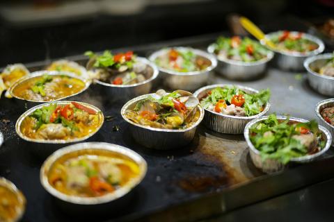 Food in foil containers at a restaurant