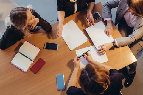 A group of professionals collaborating at a table