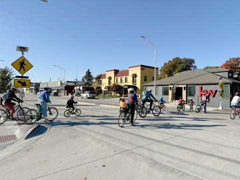 Group of bicycle riders going through crosswalk in Waldo 