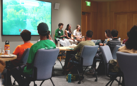 Audience gathered to listen to panel of experts in a conference room