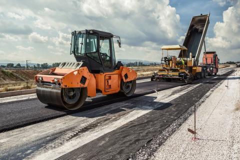 Road construction with asphalt being put on milled road