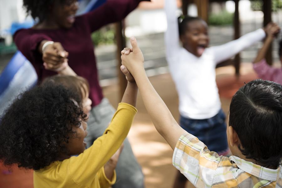 Young students and a teacher in a circle