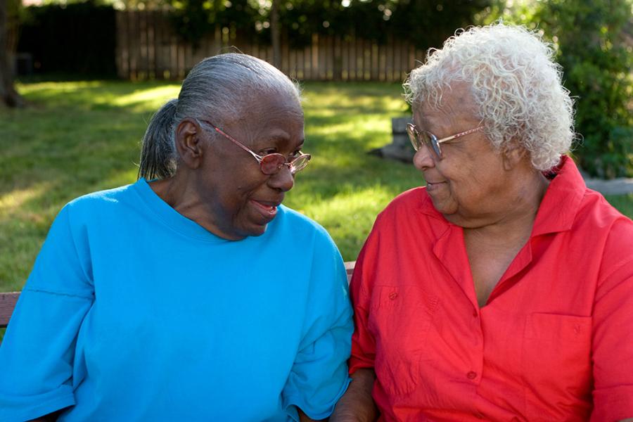 Two older women talking outdoors
