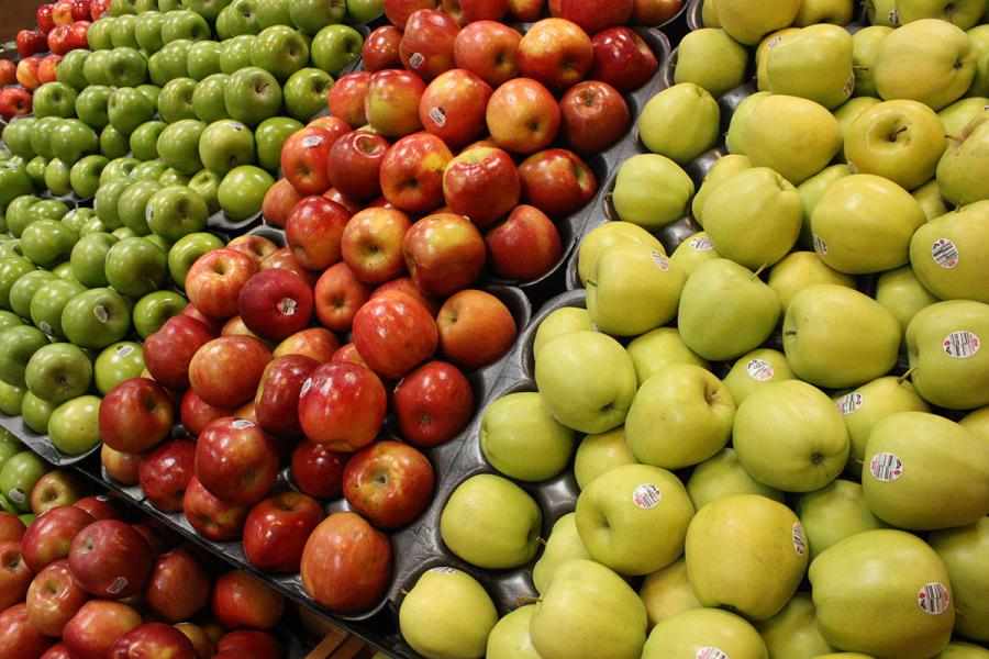 Stacks of apples at a grocery store