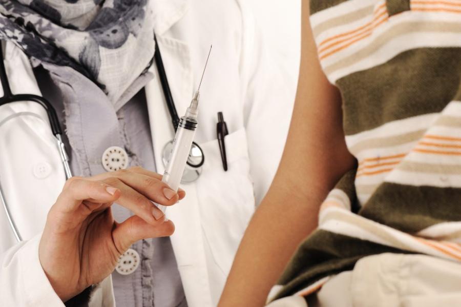 Doctor with a vaccine and young patient