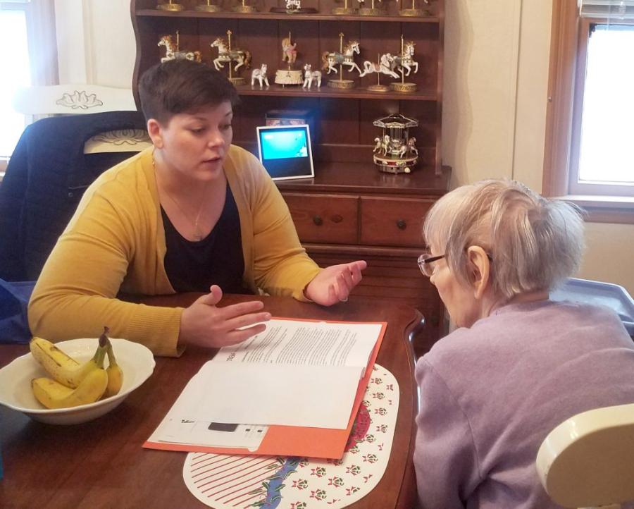 A caretaker assisting an older adult 