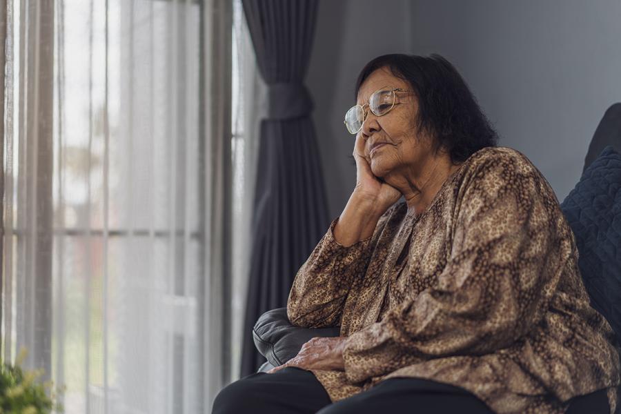 Older woman sitting and thinking