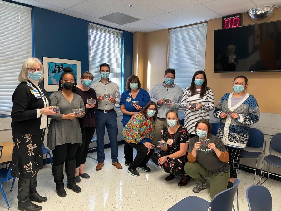 Local public health department staff with a gift box of cookies